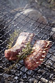 Barbecuing racks of lamb with rosemary