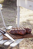 Barbecued racks of lamb with carving cutlery