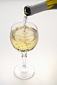 White Wine Pouring from Bottle into a Glass