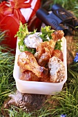 Chicken drumsticks with bread and dip for a picnic