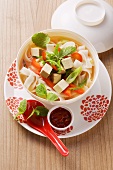 Rice noodle soup with red pepper and tofu