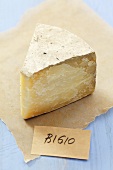 Piece of Bigio cheese (Italian hard cheese) on paper