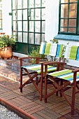 Two striped wooden, canvas chairs on a terrace