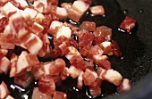 Sautéing pancetta (Italian cured belly pork) in oil