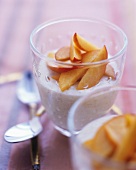 Cream dessert with nectarines in glasses
