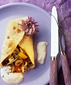 Crepe with olive filling and yoghurt sauce