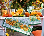 Table decoration of pumpkins and pumpkin candles