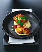 Oven-baked smoked fish cakes with bacon and curry sauce