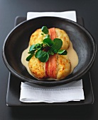 Oven-baked smoked fish cakes with bacon and curry sauce
