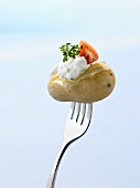 Potato cooked in its skin with herb quark & tomato on fork