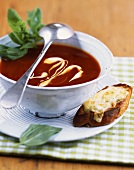 Tomato and orange soup with toasted quark on baguette
