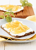 Whole-grain rye bread with soft cheese and apricot spread