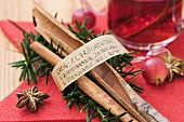Cinnamon sticks with list of ingredients for grog (rum toddy)
