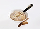 Cinnamon sugar in small bowl with spoon