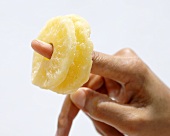 Dried pineapple slices on someone's finger