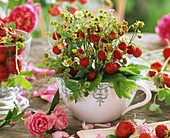 Bunch of wild strawberries in a small jug