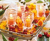 Roses, cherries and windlights on silver tray