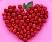 Red cherries forming a heart