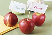 Food labels on cocktail sticks in apples