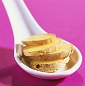 Ginger slices on china spoon