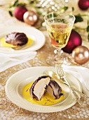 Scallops wrapped in radicchio leaves on saffron sauce