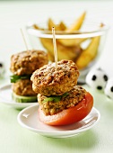 Meat patties and tomato on cocktail sticks, potato wedges