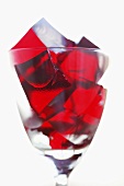 Cubes of raspberry jelly in a glass