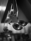 Soup ladles hanging up in a kitchen