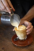 Barista making caffè latte
