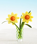 Pineapple and melon flowers in a glass