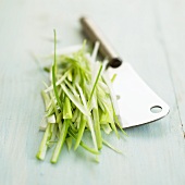 Chopped spring onions with cleaver