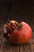 Pomegranate, halved, on wooden background