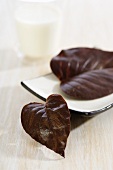 Chocolate leaves and glass of milk