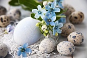 Easter eggs and quails' eggs with flowers