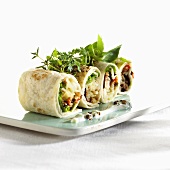 Tortilla rolls filled with lamb, mint and tomato salsa