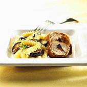 Ham-wrapped pork fillet with tapenade, aubergine slices and fusilli
