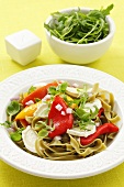 Green tagliatelle with grilled peppers, rocket and goat's cheese
