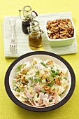 Farfalle with ham, walnuts, peas, celery and dill