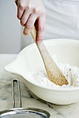 Mixing flour in a mixing bowl