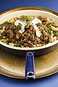 Minced lamb and aubergine sauce with sour cream and couscous (Iran)