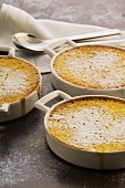 Orange and passion fruit puddings in baking dishes