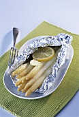 Asparagus with butter and lemon in aluminium foil