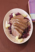 Duck breast with ginger on red cabbage with pineapple