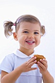Little girl holding muffin