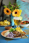 Chili con carne with onions, rice and nachos