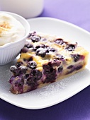 Piece of blueberry tart with cream