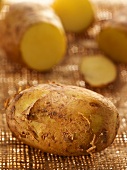 Potatoes, whole and partly sliced, on hessian