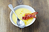 Cream of sweetcorn soup with slices of fried ham