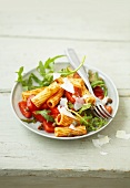 Spicy pasta salad with tomatoes, capers, rocket and Parmesan