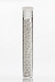 Globuli (homeopathic pellets) in glass tube